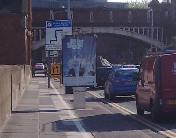 advertising panel occupies full width of cycle path