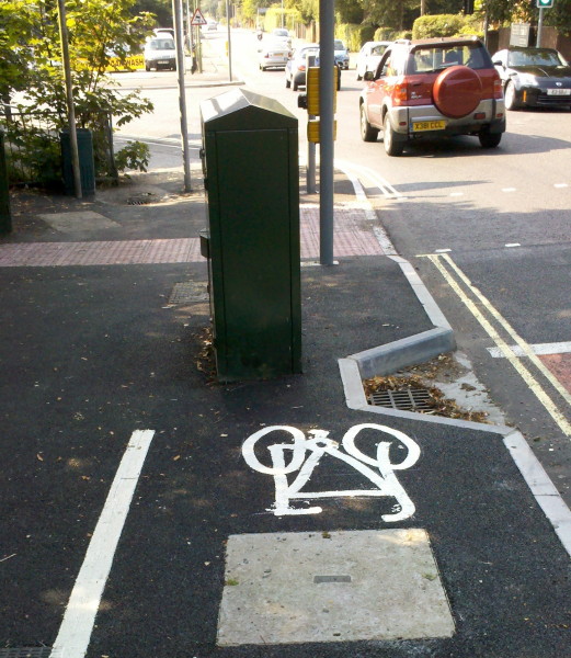 Virgin Media box and kerbed drain occupy full width of cycle path