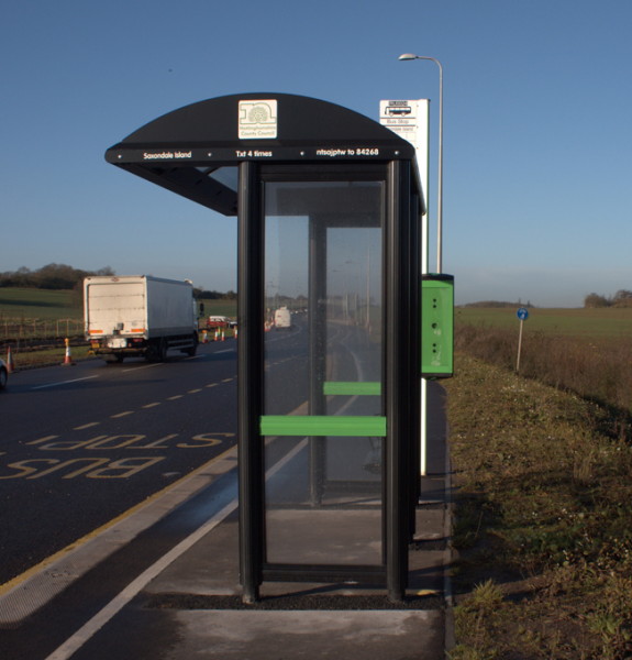 black bus shelter occupies the entire width of the cycle path