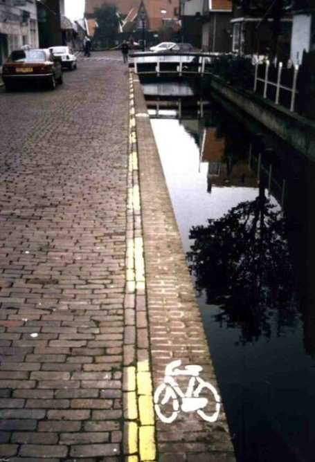 extremely thin cycle lane right on the edge of a canal