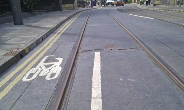 tram track runs along the middle of a cycle lane